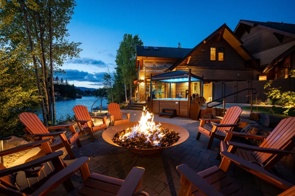 Representative Legacy Landscapes portfolio: outdoor fire-pit lounge with Adirondack chairs, planting, and a residential outdoor-living setting.